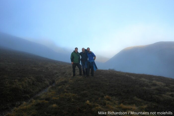 Picture of three male hikers posing for a photo hiking up towards Sharp Edge on Blencathra