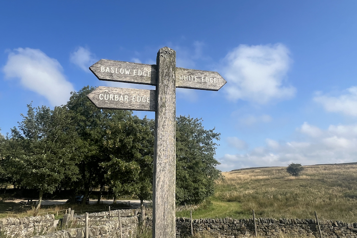 A finger-post sign directing towards Baslow Edge, Curbar Edge and White Edge