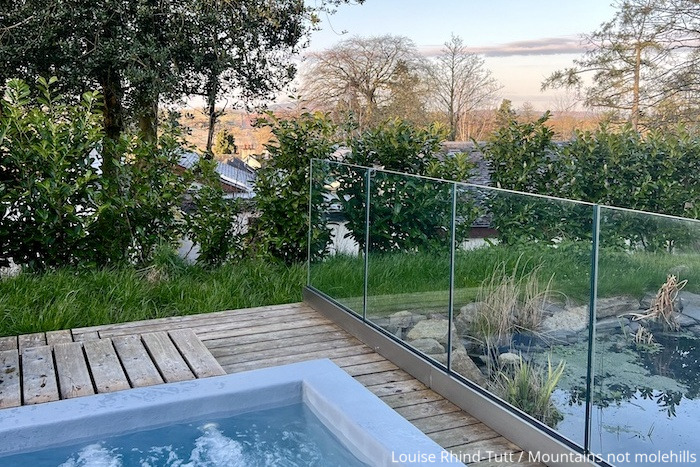 View sitting in the hot tub looking out across the fields at The Gilpin Hotel in the Lake District