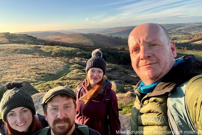 Four hikers taking a selfie at High Neb on Stanage Edge