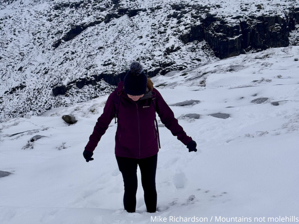 A female hiker on Kinder Scout in deep snow 