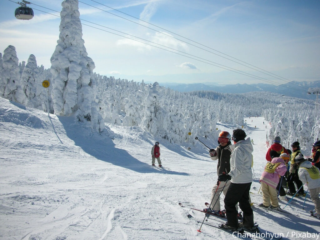 Skiers on a stationary at the side of a piste in Zao Onsen in Japan 