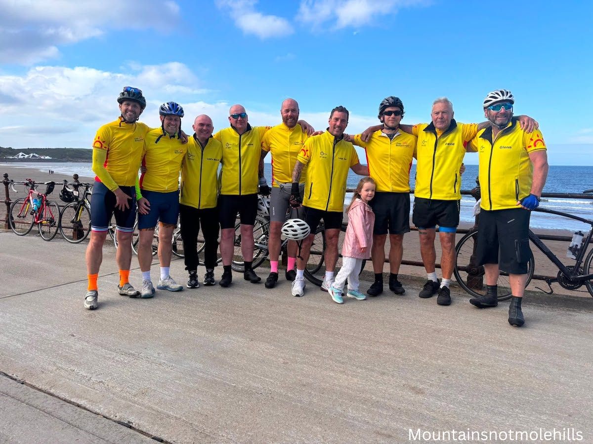 A group of cyclists posing for a photo on Scarborough beach front
